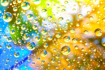 Abstract background about water or space. Multicolored stylish drops. Unusual splashes. It looks like the universe, planets and stars.