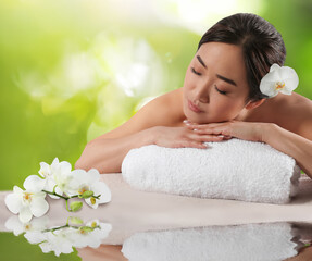 Obraz na płótnie Canvas Beautiful Asian woman lying on massage table. Spa treatment