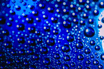 Naklejka na ściany i meble Abstract background about water or space. Multicolored stylish drops. Unusual splashes. It looks like the universe, planets and stars.