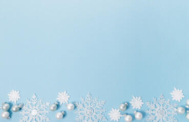 Blue Christmas holiday composition. Festive creative white pattern, xmas decor holiday ball with snowflakes on blue background.