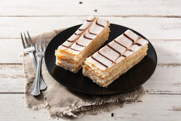 Millefoglie or French mille-feuille on white wooden table	 - obrazy, fototapety, plakaty