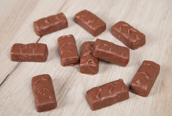 Delicious chocolate candies on a wooden background.
