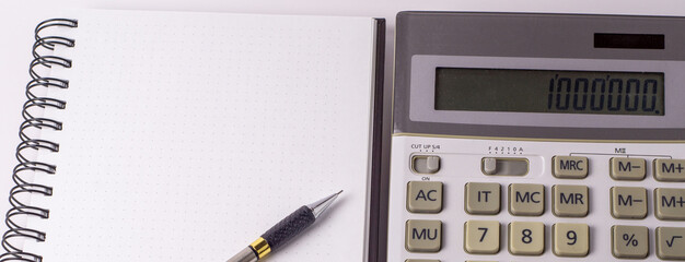 business, education, people and technology concept - close up of with calculator, pen and notebook on table