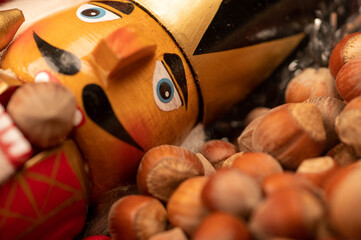 Wooden figure in the form of a soldier for chopping nuts and hazelnuts in bulk. It's time for the autumn harvest. Close-up, selective focus.