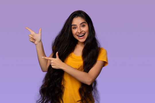 Excited Indian Woman Pointing Aside At Copy Space