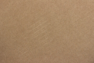 The surface structure of light brown cardboard.