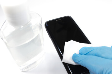Cleaning the cell phone screen with disinfectants to clean the smartphone .Prevention of contamination by the outbreak of Coronavirus COVID-19