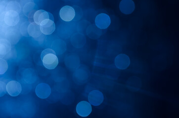 Dark blue abstract bokeh background.