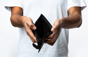 Unrecognizable Black Man Showing Empty Wallet Standing Over White Background