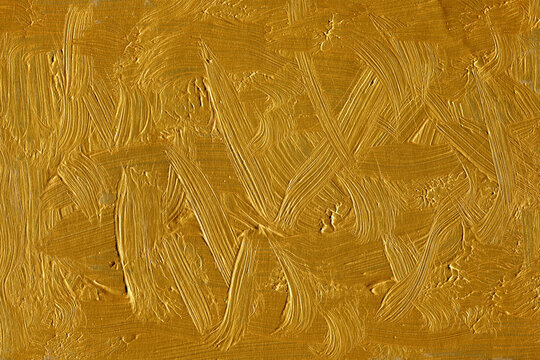 Modern contemporary acrylic background. Gold paint texture made with a brush. Luxury abstract painting on paper. Mess on the canvas.