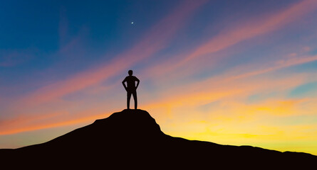 Silhouette of businessman on mountain top over sunset sky background, motivational, business,...