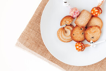 Butter cookies in a white plate on a white background.