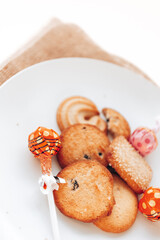 Butter cookies in a white plate on a white background.