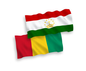 National vector fabric wave flags of Tajikistan and Guinea isolated on white background. 1 to 2 proportion.
