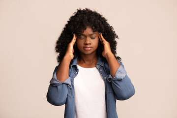 Upset african american lady having headache, grey background