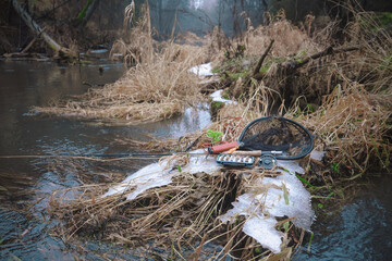 Box with flies on the background of the river. Fly fishing.