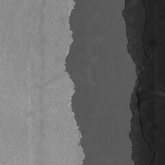 Black torn paper collage close-up. Texture made from various paper and cardboard parts. Damaged old paper background. Vintage blank wallpaper. Material design backdrop.