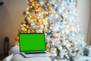 laptop with green screen - chromakey near New Year's decorations. christmas theme.