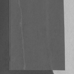 Fototapeta premium Black torn paper collage close-up. Texture made from various paper and cardboard parts. Damaged old paper background. Vintage blank wallpaper. Material design backdrop.