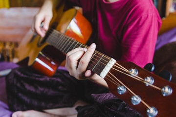 Close Up Of Male Musical Performer Playing On Brown Clasic Guitar.