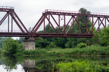 Old rusty railway bridge over the river
