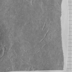 Black torn paper collage close-up. Texture made from various paper and cardboard parts. Damaged old paper background. Vintage blank wallpaper. Material design backdrop.