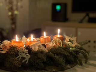 All four candles burning on a home made advent wreath at the fourth advent, a few days before christmas.