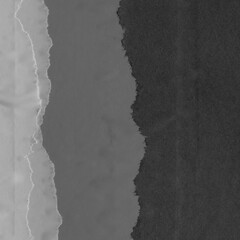 Black torn paper collage close-up. Texture made from various paper and cardboard parts. Damaged old paper background. Vintage blank wallpaper. Material design backdrop.