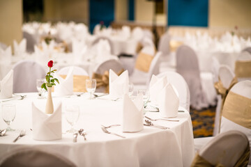 Elegant table setting for wedding ceremony, Empty wine glasses, cutlery set knife, spoon, fork, napkin and bouquet in restaurant