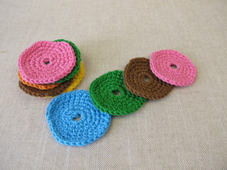 Fototapeta na wymiar Crocheted, reusable, washable cosmetic pads from colorful wool