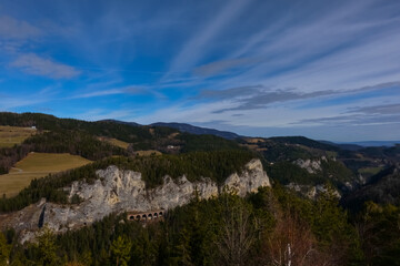 Fototapeta na wymiar beautiful view to mountains rocks forest and a old railway bridge