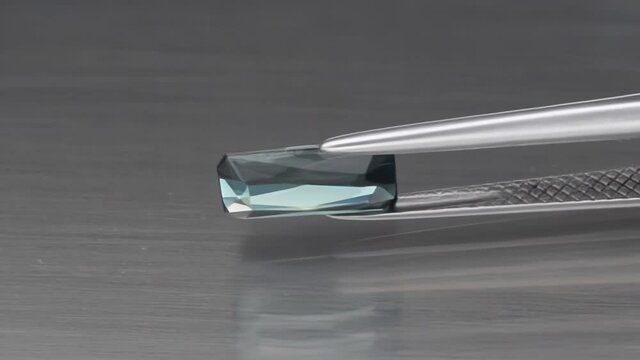 natural green indicolite tourmaline on the grey background