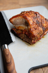 Grilled marinated Pork Belly barbecue with cutting knife and cutting board,