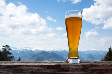 Wheat beer glass in front of mountain view panorama