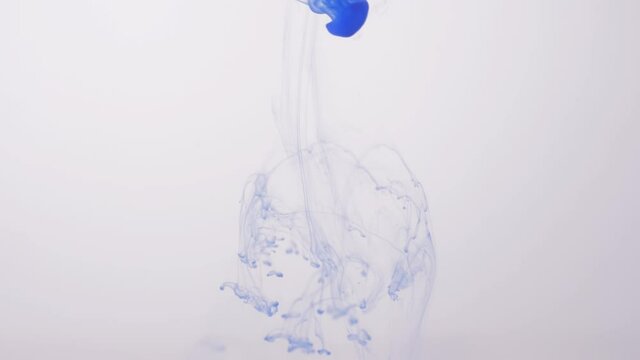 drop blue ink paint in water slow motion
