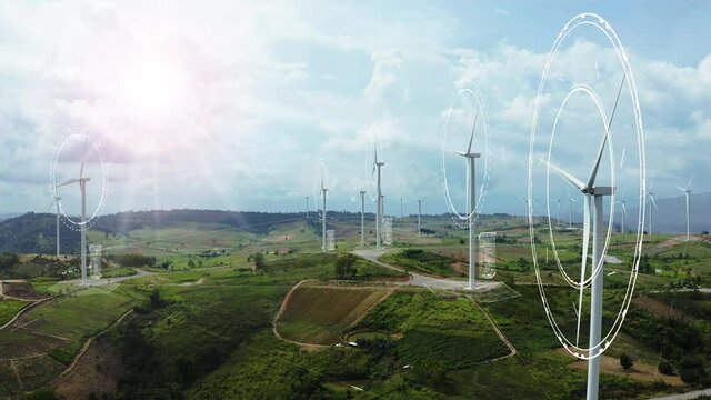 Aerial view of windmills with digitally generated holographic display tech data visualization. Wind power turbines generating clean renewable energy for sustainable development in a green ecologic way