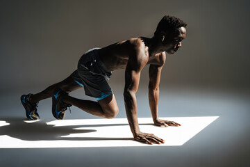 Fototapeta na wymiar Confident young african sportsman exercising