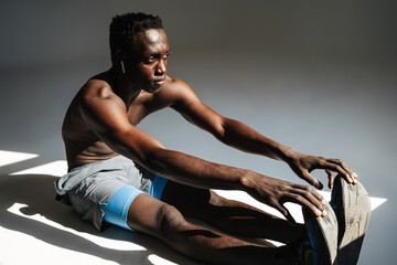 Confident young african sportsman exercising
