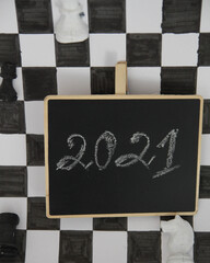 Hand Drawing New Year 2021 Idea Concepts on Blackboard Background . Chees board. Greeting cards design