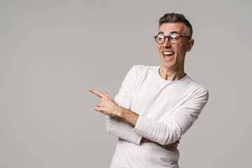 Excited young man presenting copy space isolated