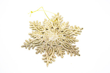 Christmas tree shiny toy in the form of a snowflake isolated on a white background. Christmas card on white background
