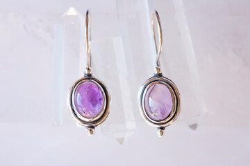 pair of sterling silver amethyst mineral earrings on natural background