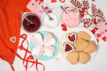 cookie heart decorated with glaze white and pink for Valentine's day, close-up, baking for the holiday. decorative hearts top view