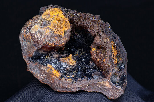 Goethite geode (hydrogoethite) in limonite on a black background, iron ore. Deposit Russia
