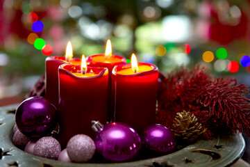 Four red candles for Advent. Christmas background.