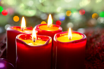 Four red candles for Advent. Christmas background.