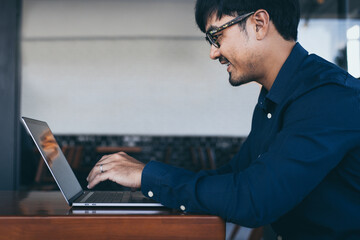 man work using texting cell phone typing computer.chatting on mobile,laptop contact us at workplace Thinking investment plan Investor.searching information internet.connecting people concept