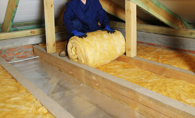 Man installing thermal roof insulation