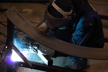 Metal workers use manual labor, Skilled welder, Factory workers making OT. Welder is welding the...