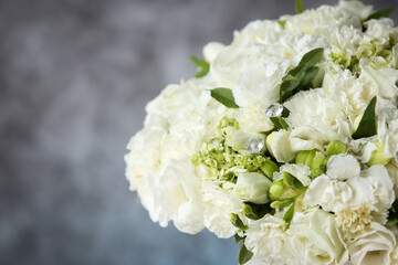 Wedding bouquet with white roses under the water drops on the mirror against grey and blue background. . 
